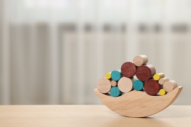 Photo of Wooden balance toy on table indoors, space for text. Children's development