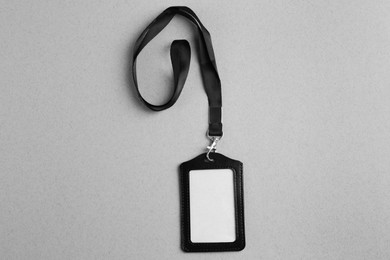 Blank badge on light grey background, top view. Mockup for design