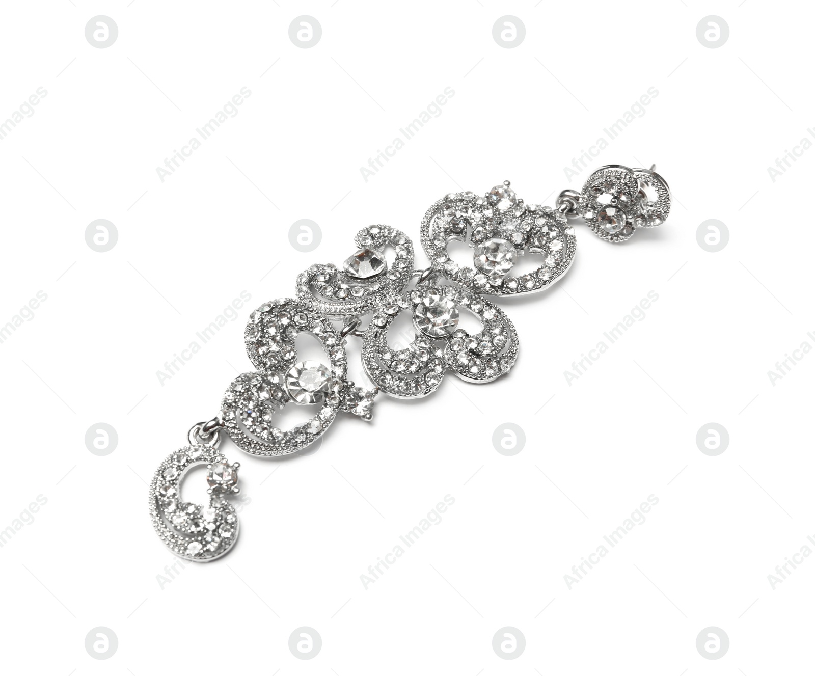 Photo of Beautiful silver earring isolated on white. Luxury jewelry