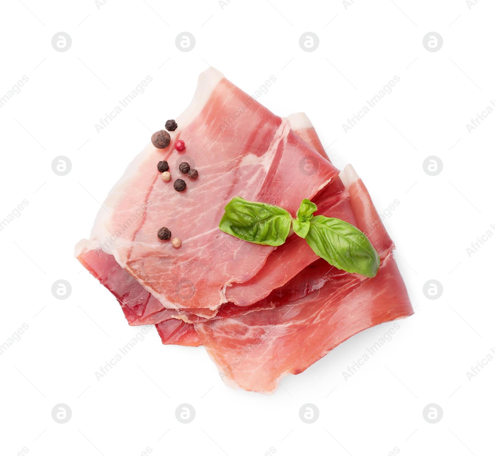 Photo of Slices of delicious jamon, spices and basil isolated on white, top view