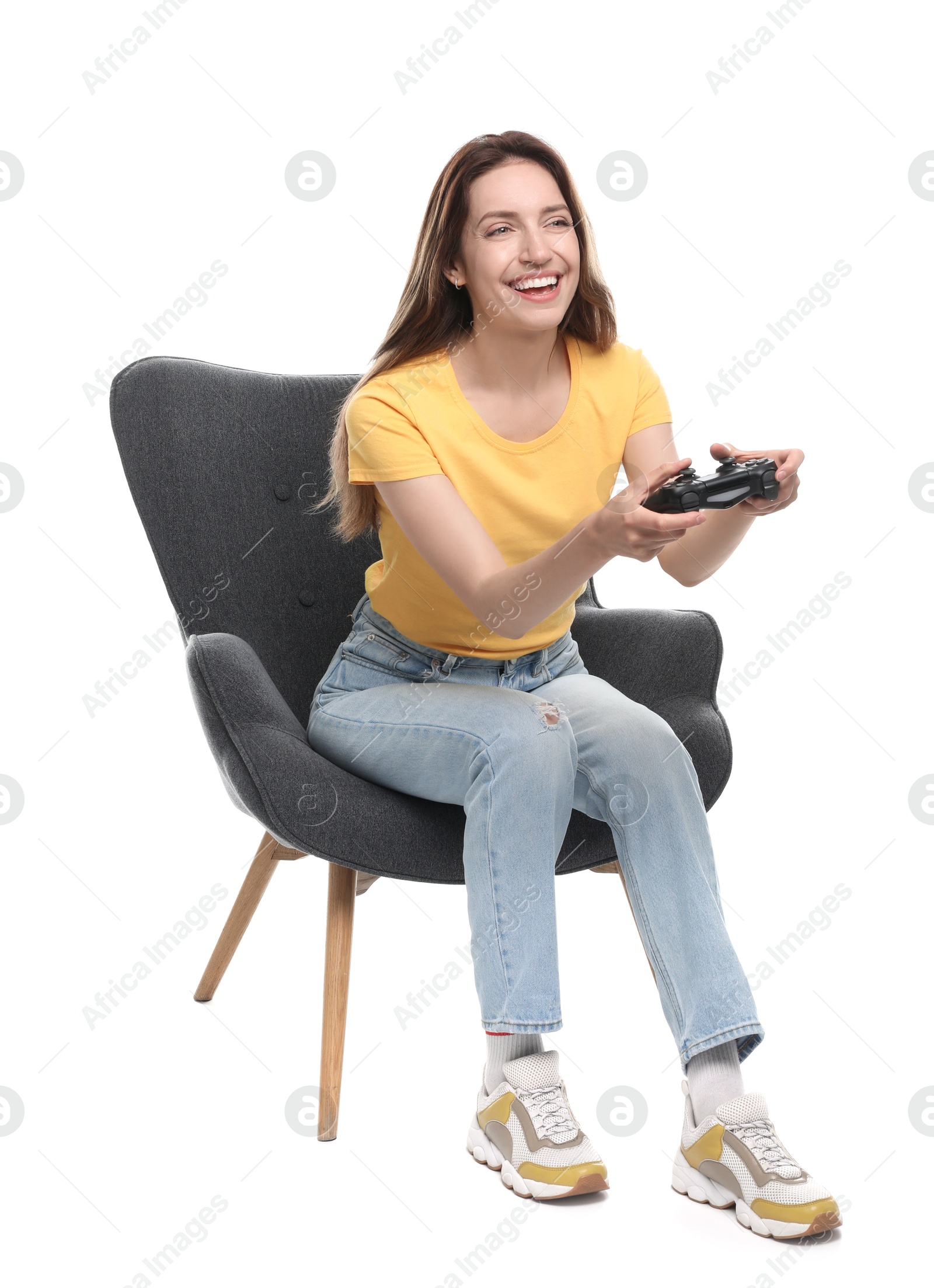 Photo of Happy woman with game controller sitting in armchair on white background