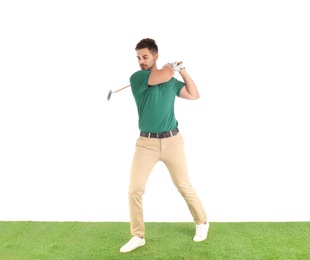 Young man playing golf on course against white background