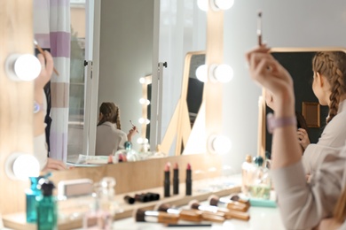 Photo of Young woman in makeup room, closeup