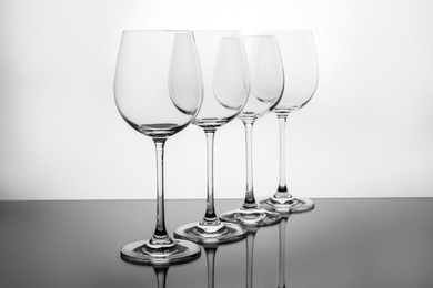 Photo of Row of empty wine glasses on white background