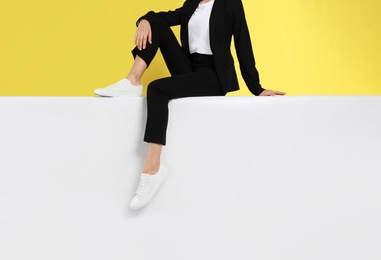 Photo of Woman wearing stylish shoes on color background, closeup