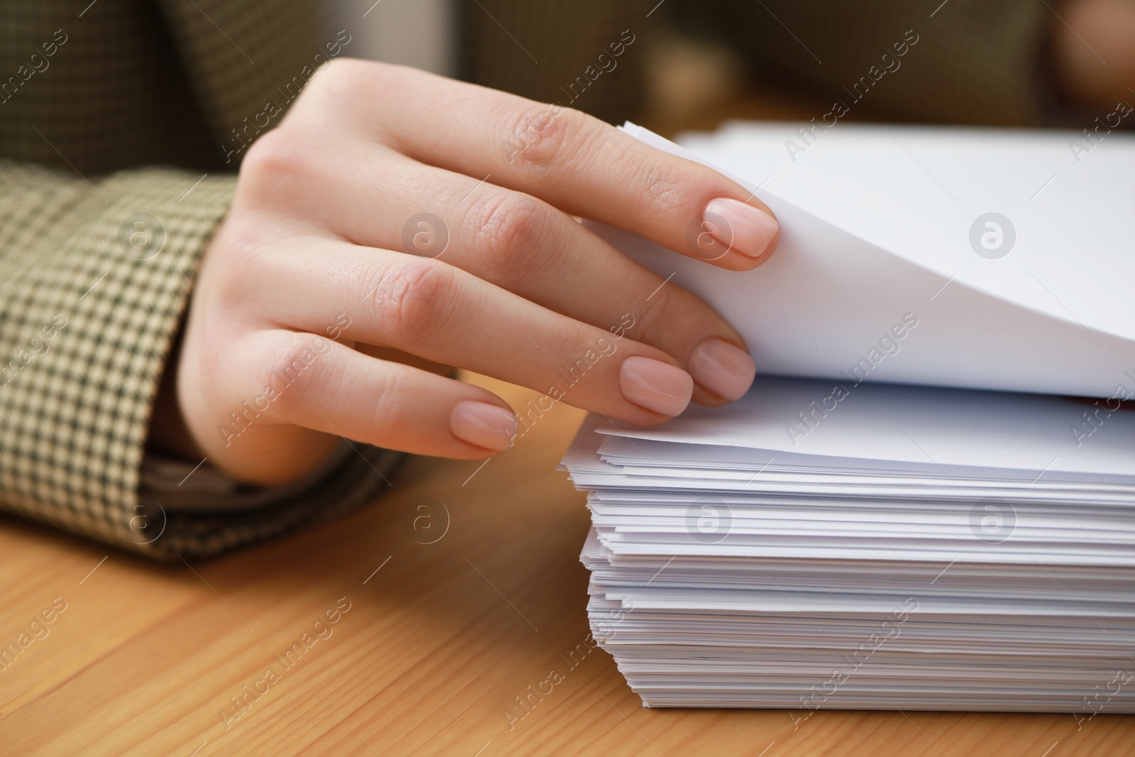 Photo of Woman working with documents at table in office, closeup