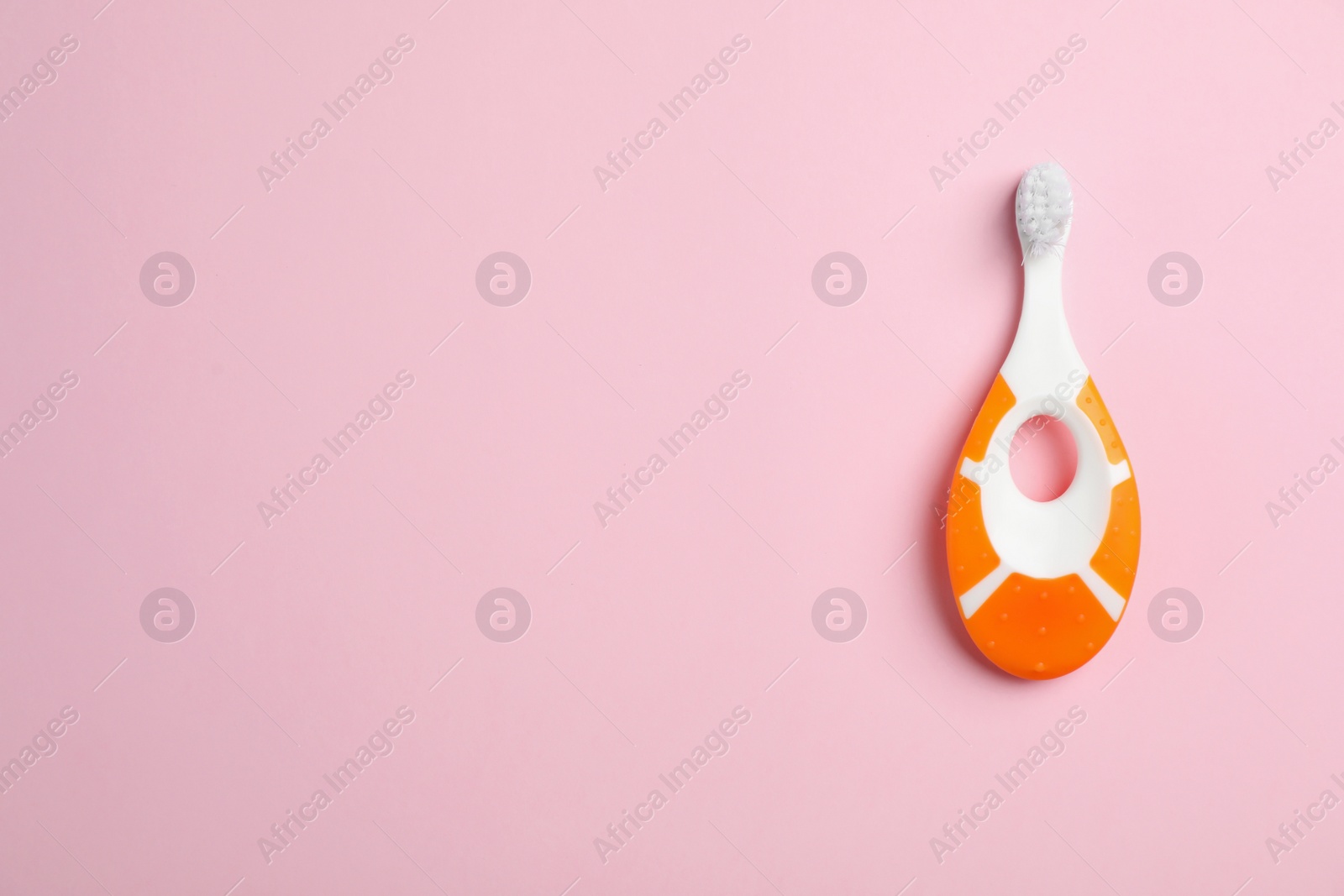 Photo of Manual toothbrush for child on color background, top view with space for text