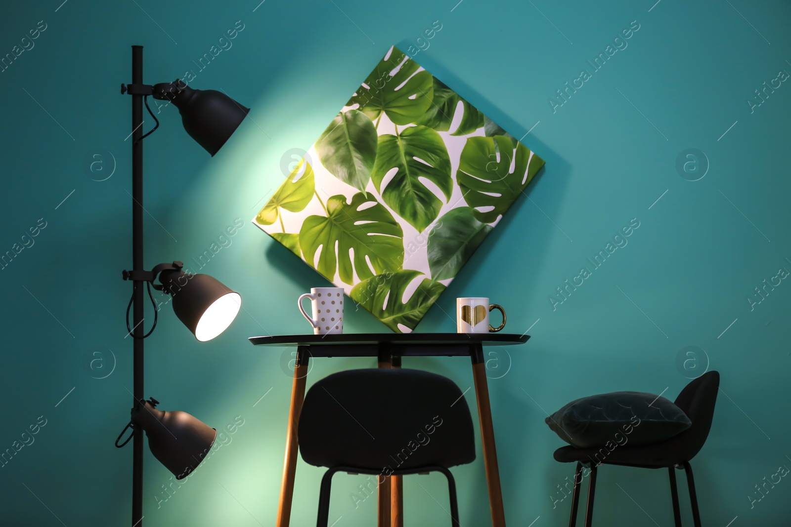 Photo of Modern floor lamp with stylish furniture on color background