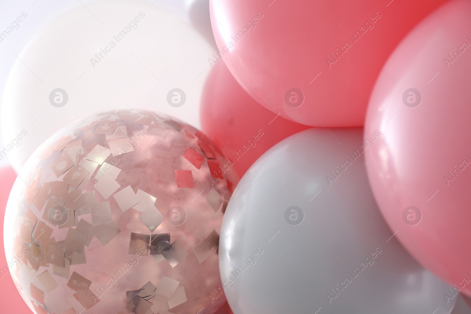 Photo of Beautiful colorful balloons on light background, closeup