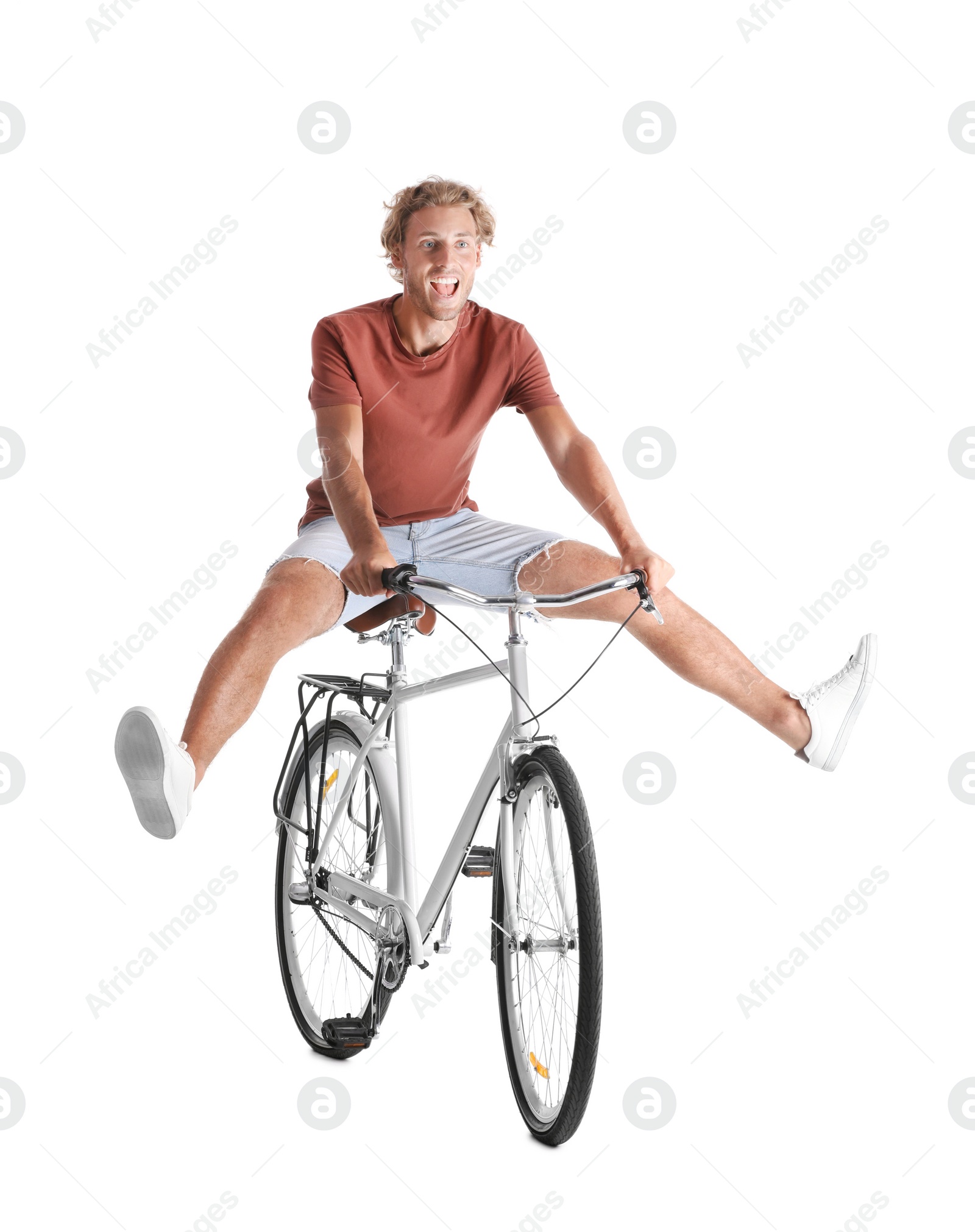 Photo of Handsome young man riding bicycle on white background