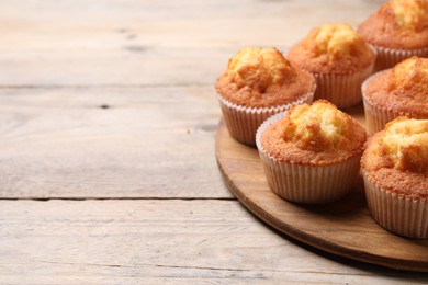 Delicious sweet muffins on wooden table, closeup. Space for text