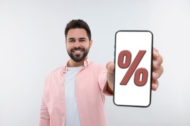 Discount, offer, sale. Man showing mobile phone with percent sign on screen, white background