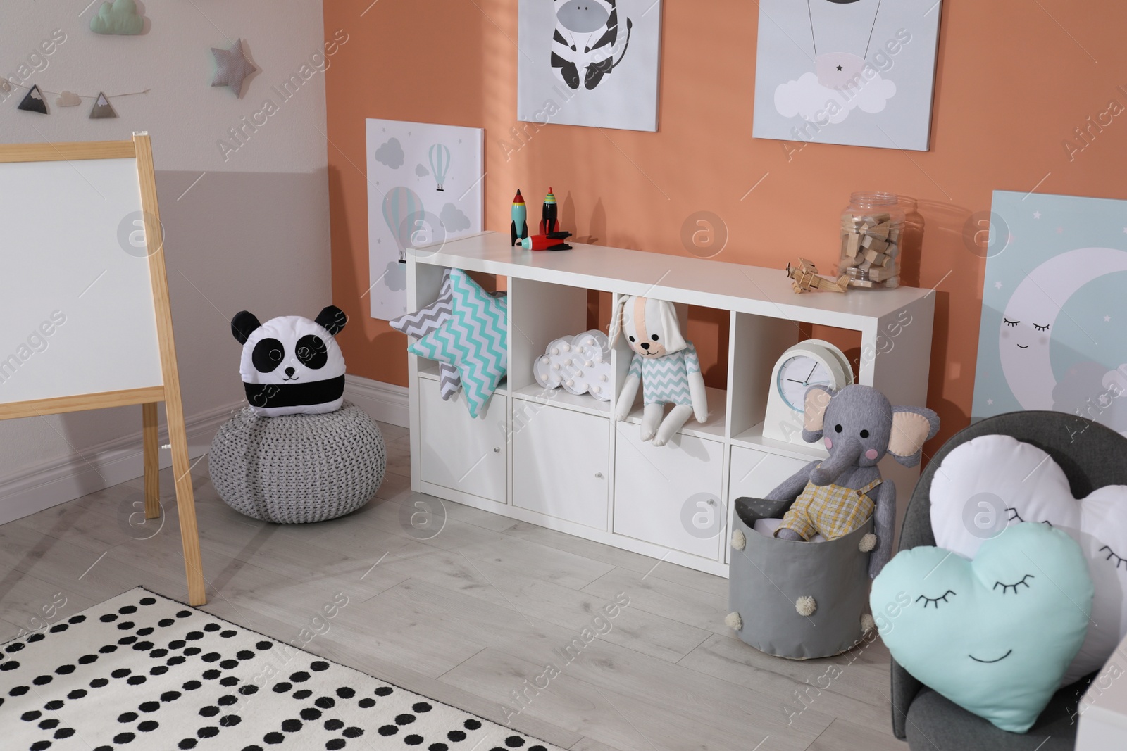 Photo of Cute child's room interior with toys and modern furniture