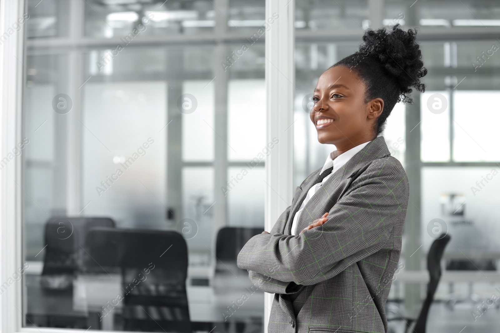 Photo of Happy woman with crossed arms in office, space for text. Lawyer, businesswoman, accountant or manager