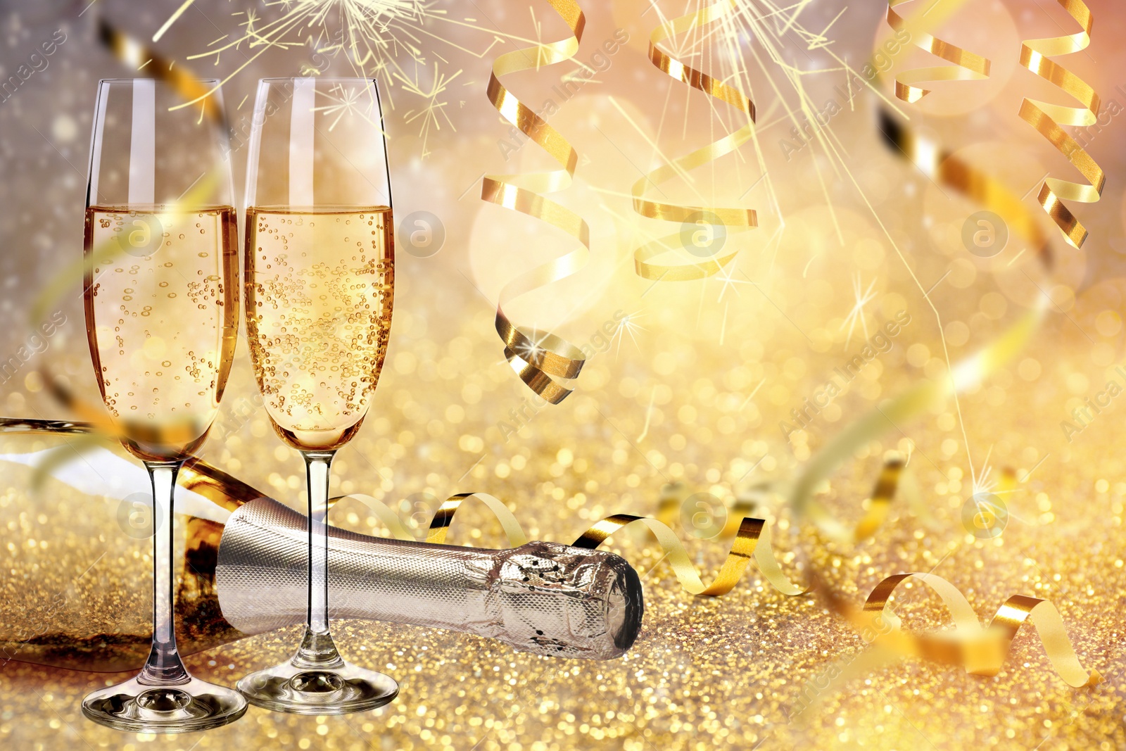 Image of Glasses and bottle of sparkling wine on bright festive background 