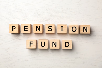 Photo of Cubes with words "PENSION FUND" on wooden background