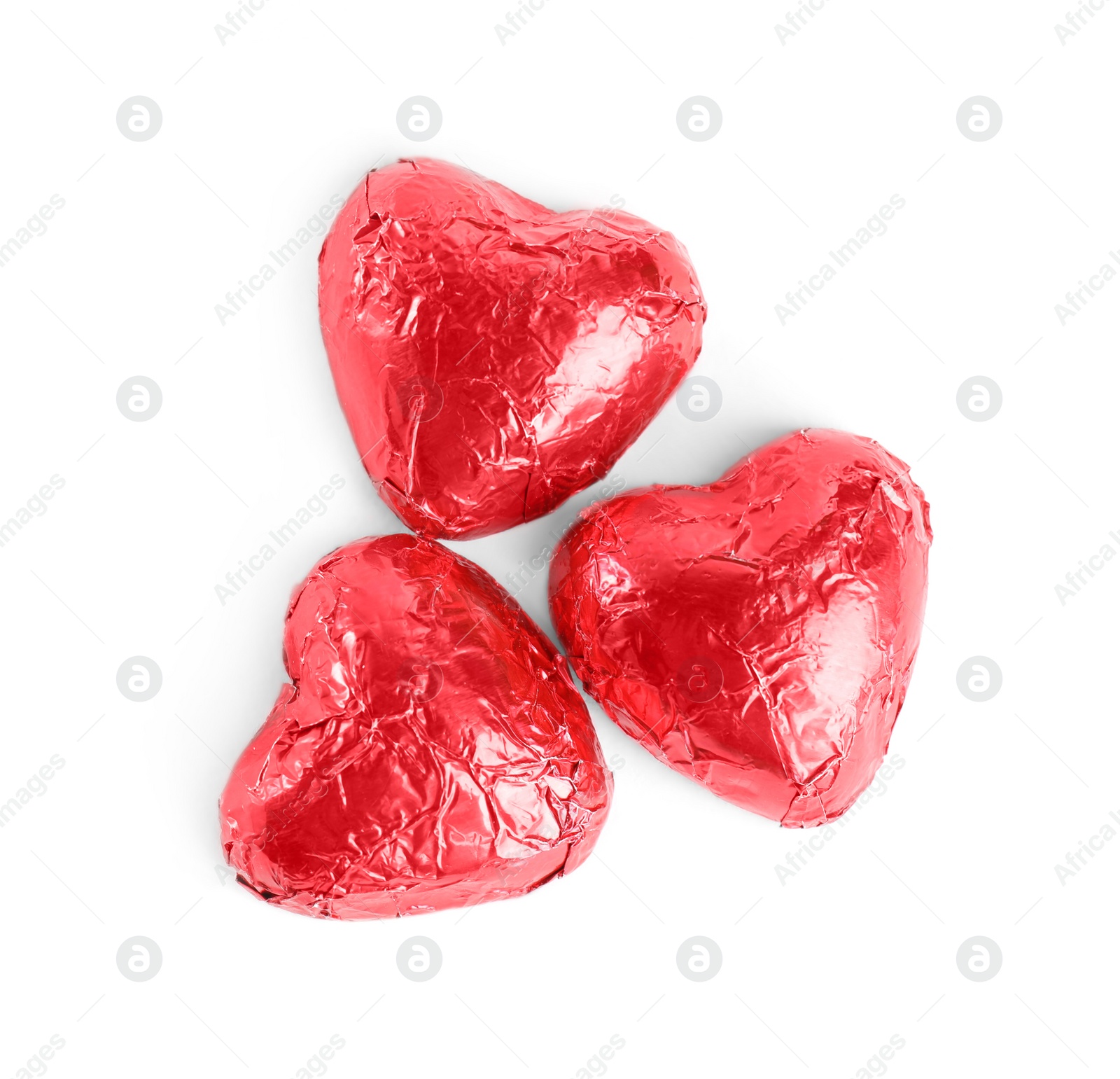 Photo of Heart shaped chocolate candies on white background, top view