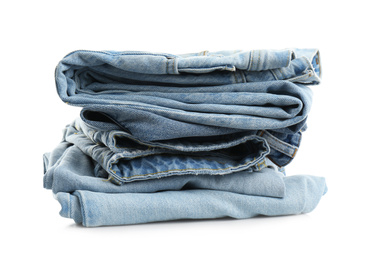 Stack of folded jeans isolated on white