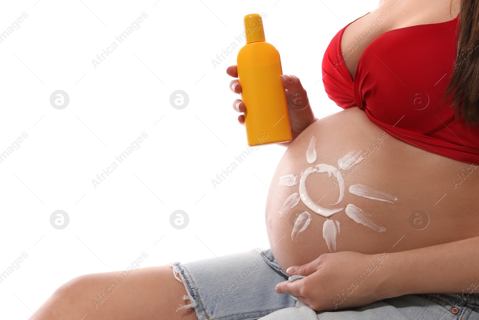 Photo of Young pregnant woman with sun protection cream on white background, closeup