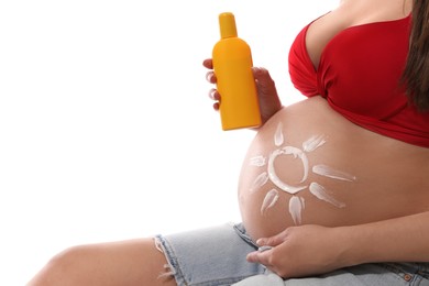 Photo of Young pregnant woman with sun protection cream on white background, closeup