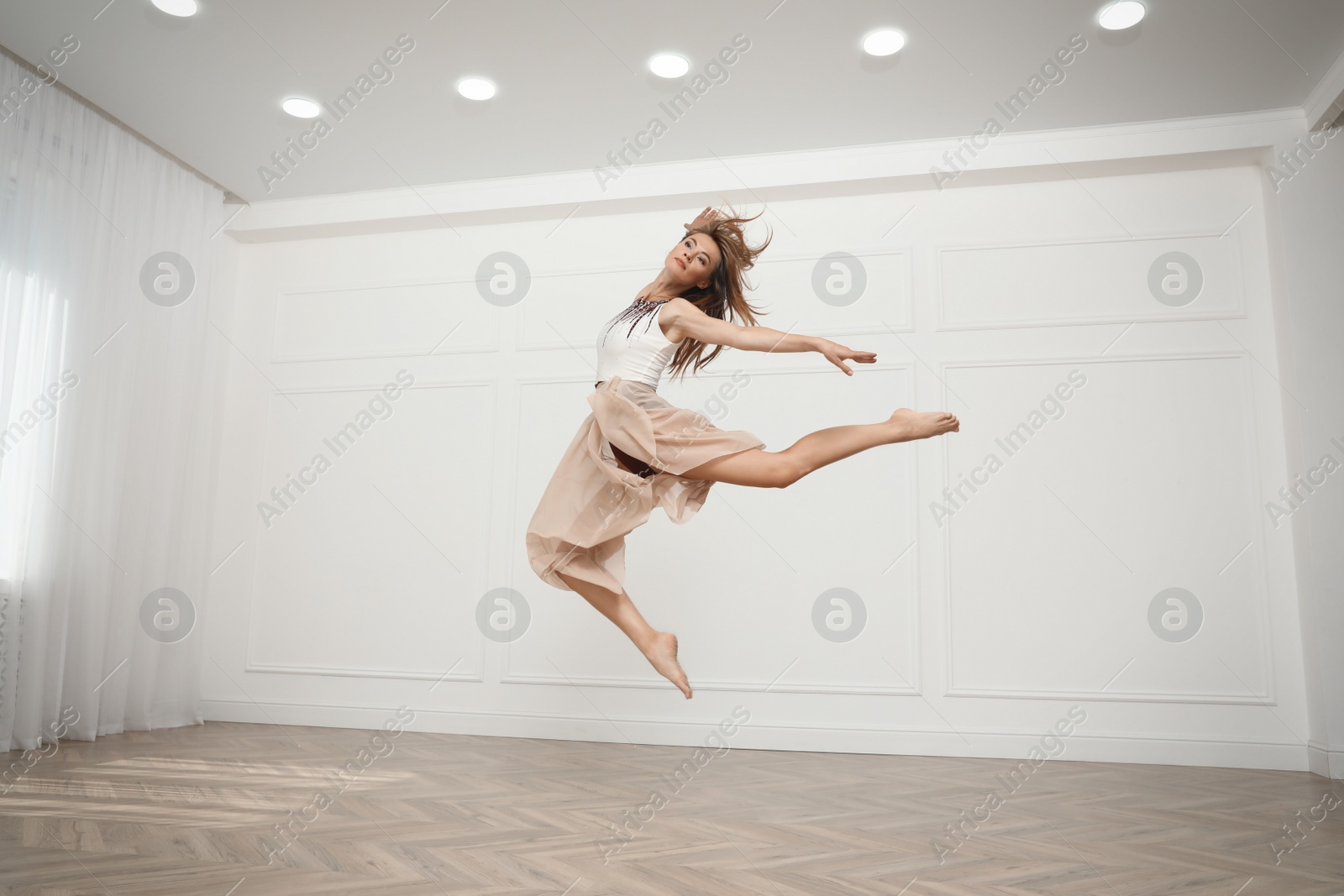 Photo of Beautiful professional dancer practicing moves in studio