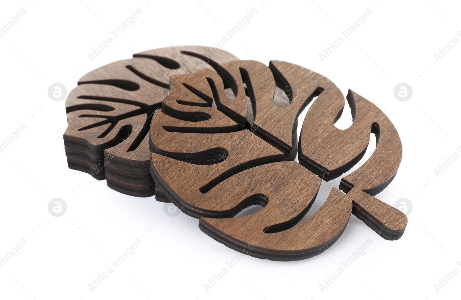 Photo of Leaf shaped wooden cup coasters on white background