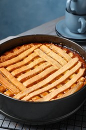 Photo of Delicious apricot pie in baking dish on table, closeup