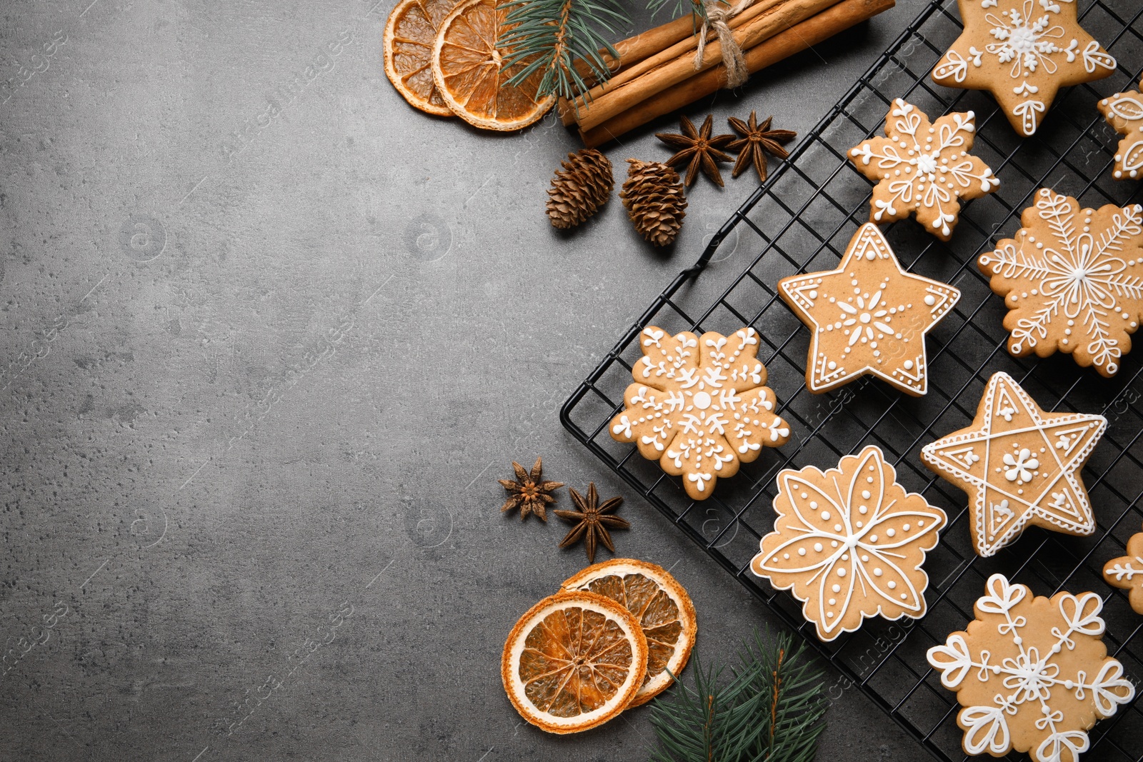 Photo of Tasty Christmas cookies and festive decor on grey table, flat lay. Space for text