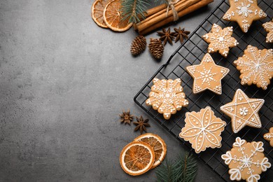 Tasty Christmas cookies and festive decor on grey table, flat lay. Space for text