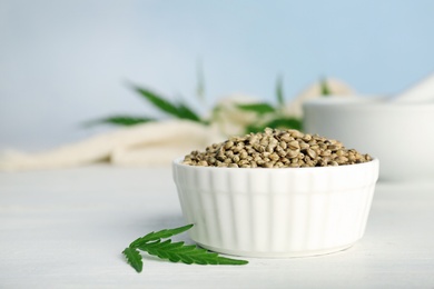 Ceramic bowl with hemp seeds on table