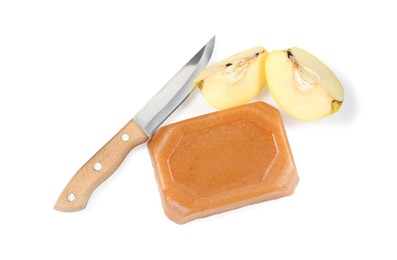 Delicious sweet quince paste, knife and fresh cut fruit isolated on white, top view