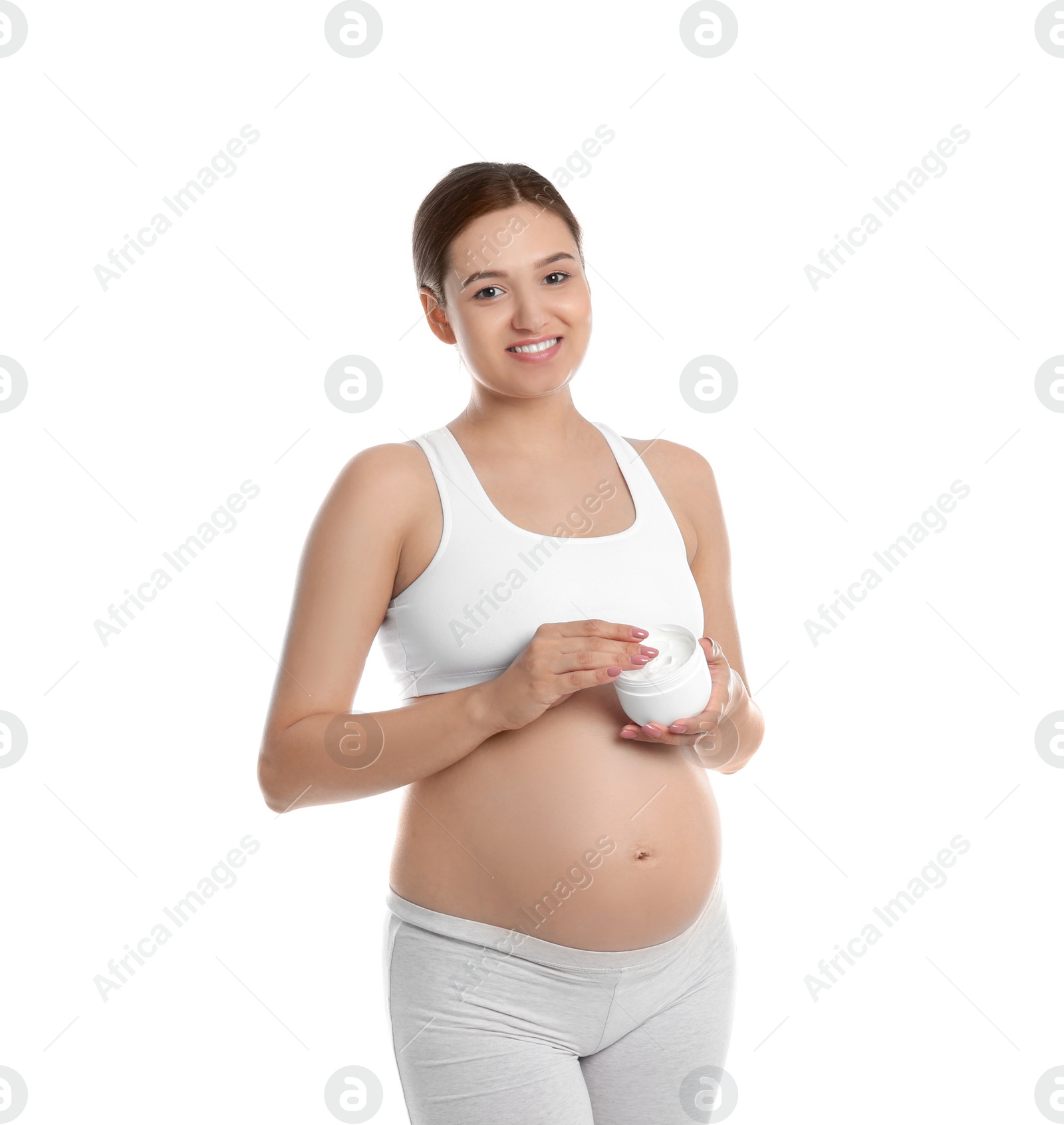 Photo of Pregnant woman holding body cream on white background