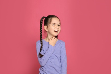 Photo of Little girl scratching neck on color background. Annoying itch