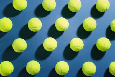 Photo of Tennis balls on blue background, flat lay. Sports equipment