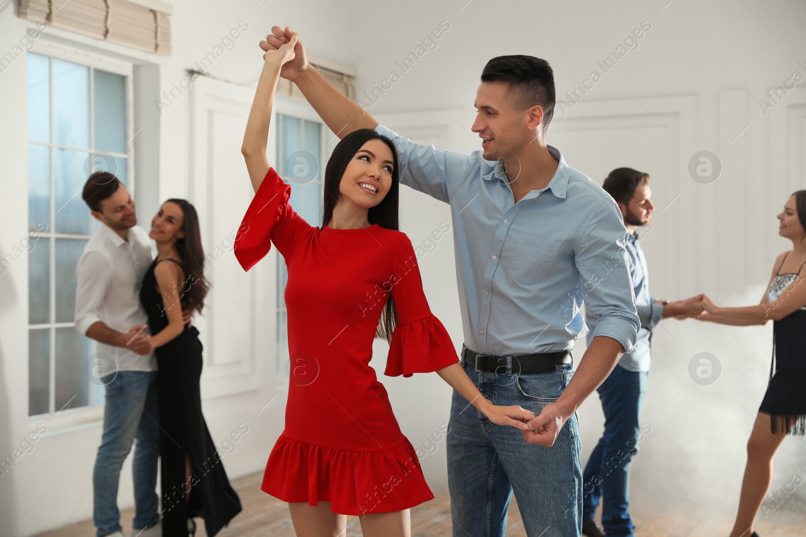 Photo of Lovely young couple dancing together at party