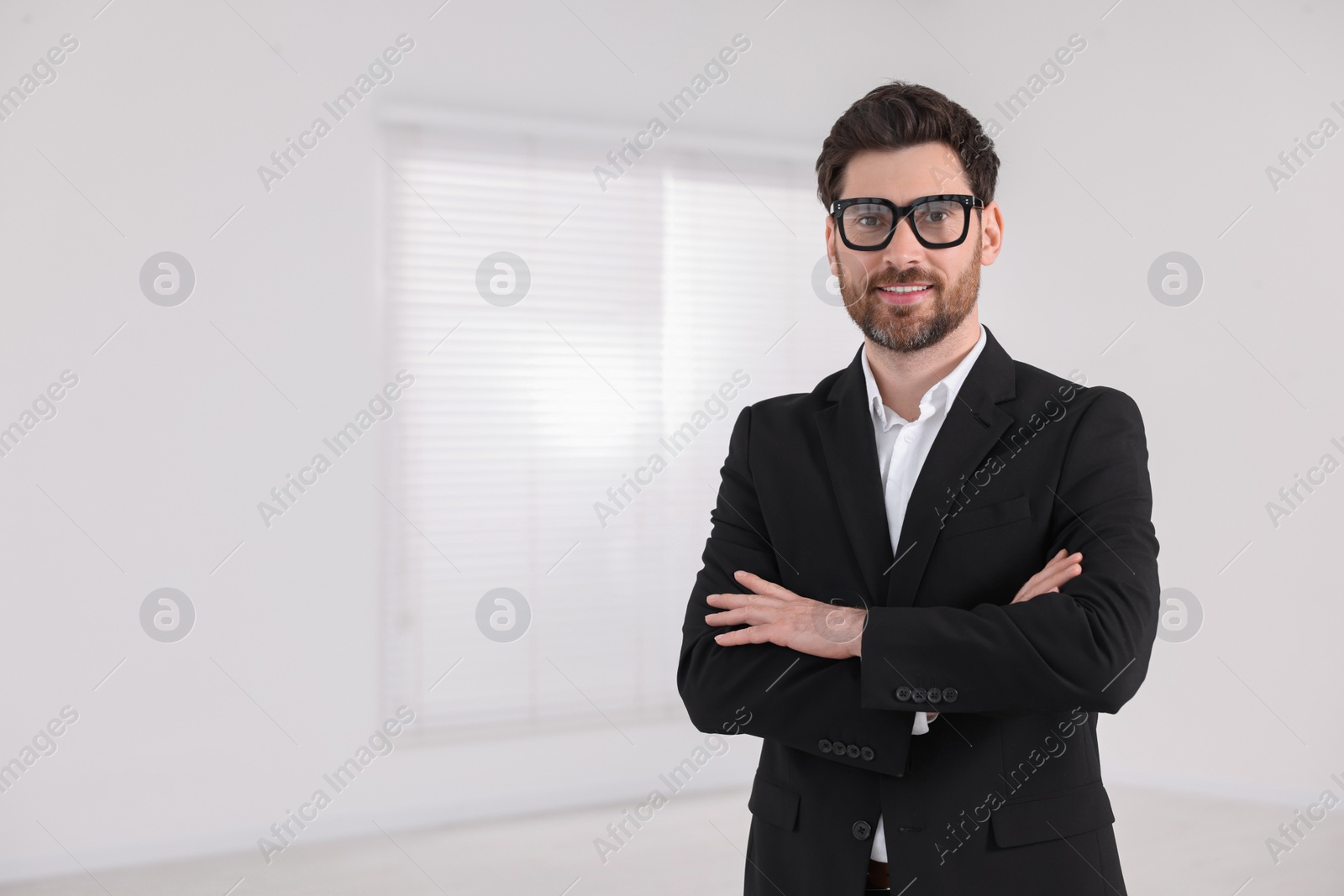 Photo of Happy real estate agent in new apartment. Space for text