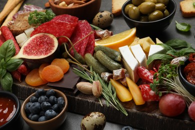 Photo of Set of different delicious appetizers served on grey table, closeup