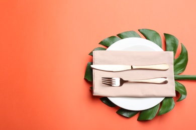 Photo of Elegant table setting on orange background, flat lay. Space for text