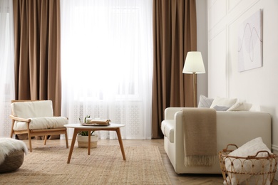 Photo of Modern furniture and window with curtains in stylish room interior