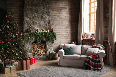 Festive interior with decorated Christmas tree and fireplace