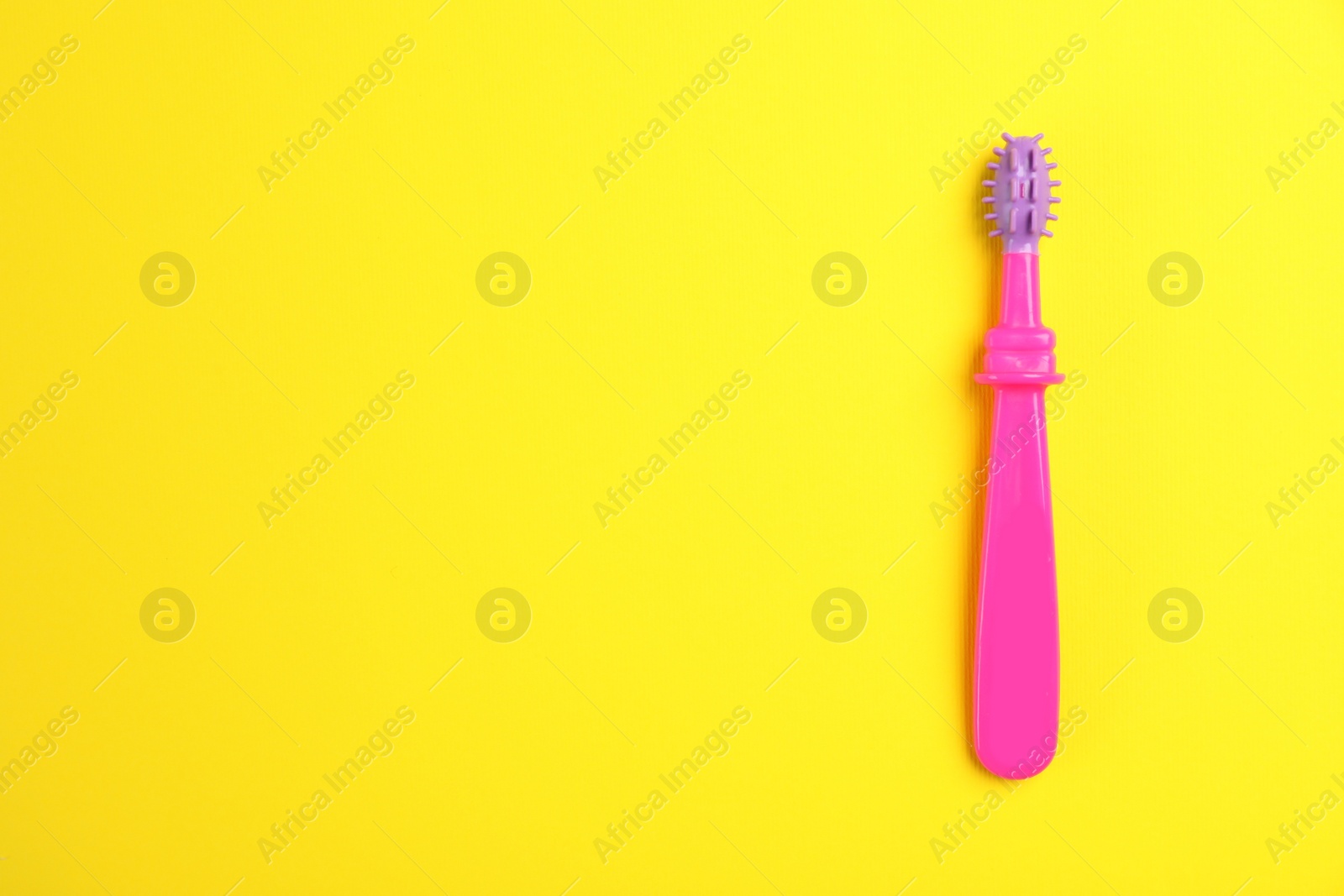 Photo of Manual toothbrush for child on color background, top view with space for text