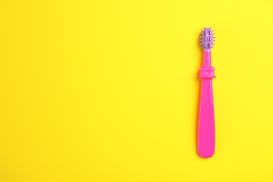 Photo of Manual toothbrush for child on color background, top view with space for text