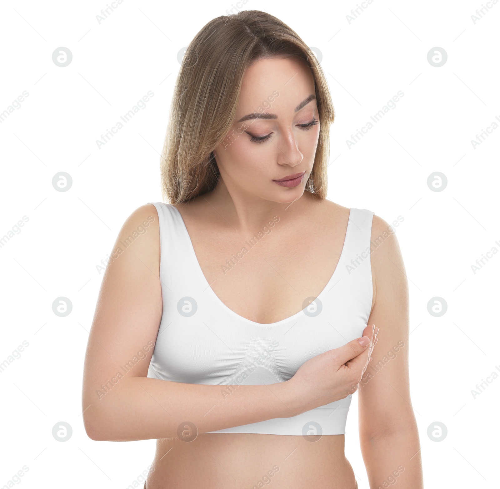 Photo of Mammology. Young woman doing breast self-examination on white background