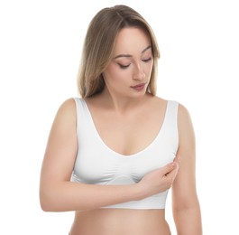 Photo of Mammology. Young woman doing breast self-examination on white background