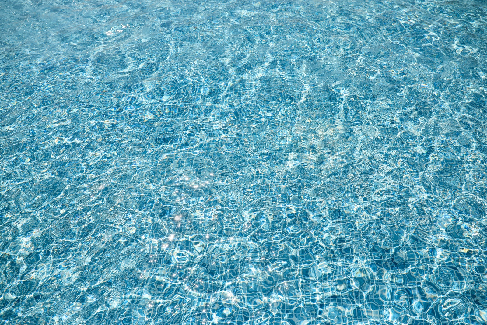 Photo of Swimming pool with clean blue water as background. Summer vacation