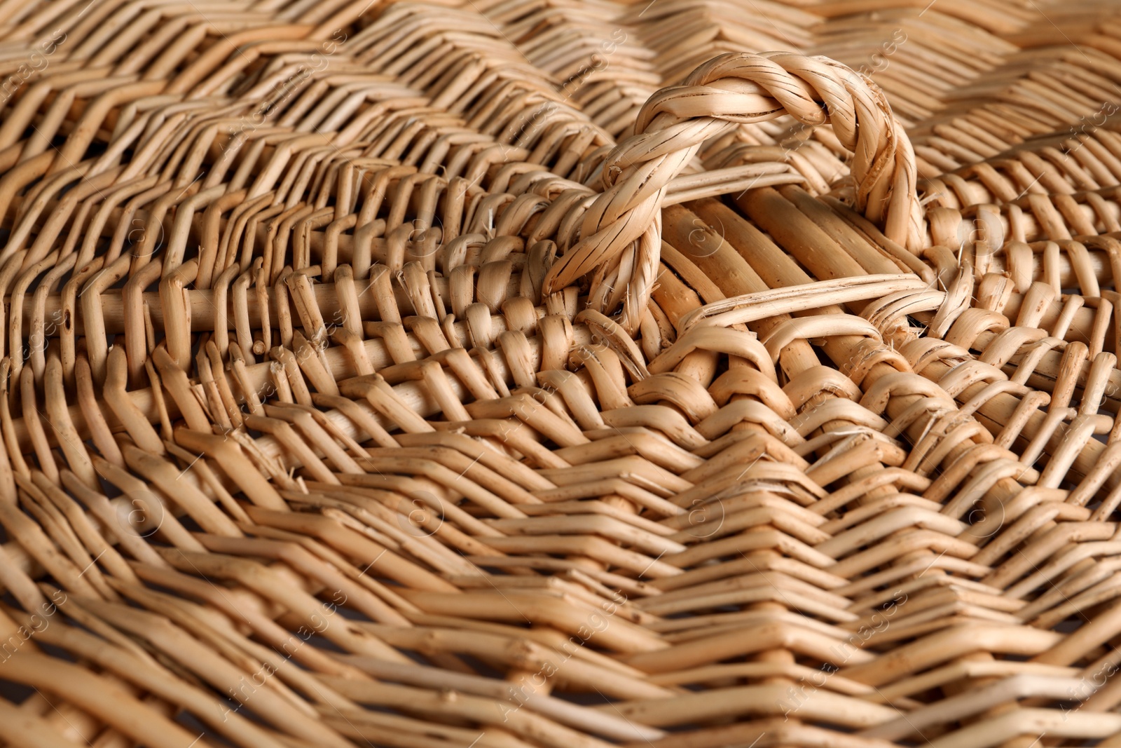 Photo of Lid of handmade wicker basket as background, closeup