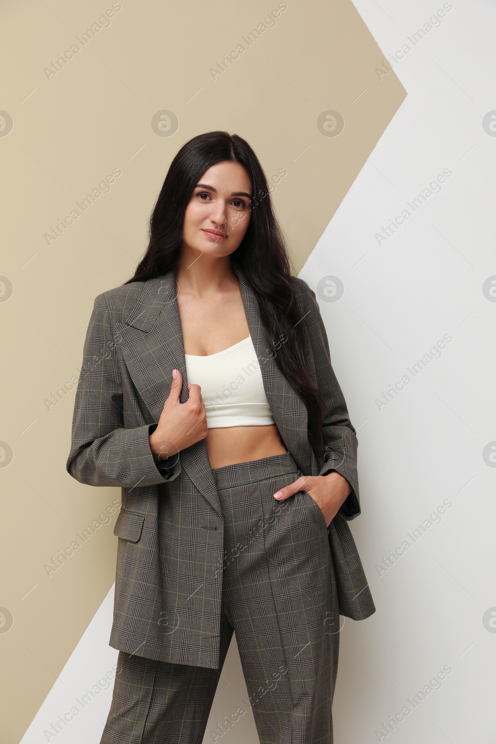 Photo of Beautiful woman in formal suit on color background. Business attire