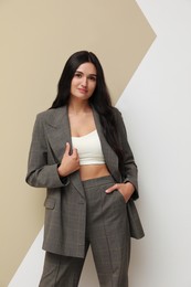 Photo of Beautiful woman in formal suit on color background. Business attire