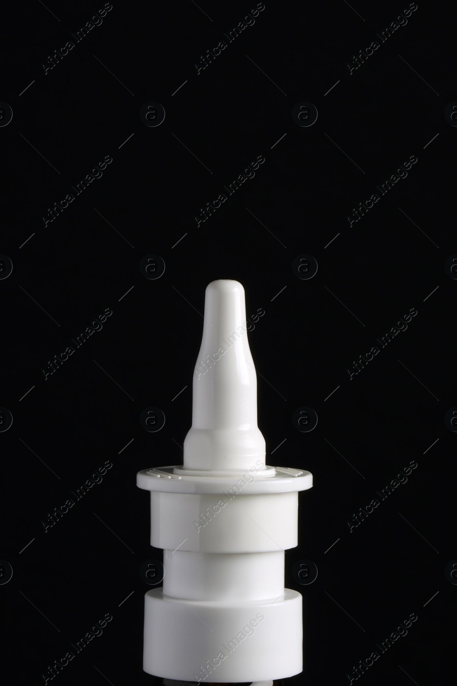 Photo of Bottle of nasal spray on black background, closeup