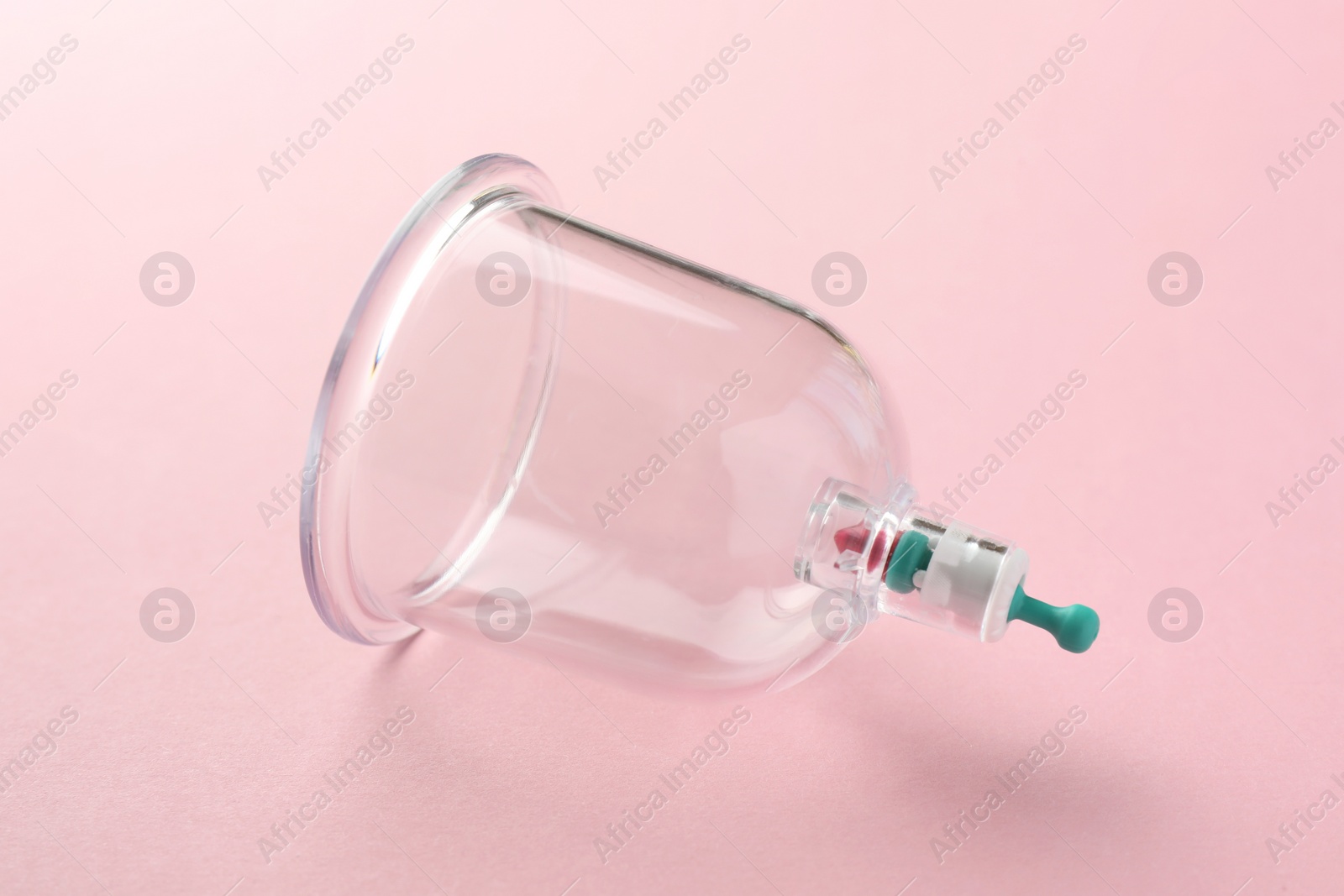 Photo of Plastic cup on pink background. Cupping therapy